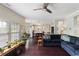 Open-concept living room with a ceiling fan and seamless transition to the adjacent kitchen at 1274 Ridge Vista Ct, Lawrenceville, GA 30043
