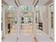 Well-lit bathroom with double mirrors, an oval soaking tub, and glass-enclosed shower stall at 2005 Sweetgum Trl, Cumming, GA 30041