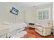 Light-filled bedroom features hardwood floors and a comfortable seating area at 2005 Sweetgum Trl, Cumming, GA 30041