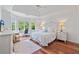 Spacious bedroom boasts hardwood floors, a tray ceiling, and a cozy seating area by bright windows at 2005 Sweetgum Trl, Cumming, GA 30041
