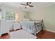 Relaxing bedroom is complete with hardwood floors and a large window for natural light at 2005 Sweetgum Trl, Cumming, GA 30041