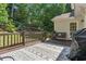 Outdoor deck with a grill, seating and a view of the wooded backyard, perfect for entertaining at 2005 Sweetgum Trl, Cumming, GA 30041