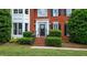 Charming home entrance with a black front door and elegant landscaping at 2005 Sweetgum Trl, Cumming, GA 30041