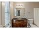 Bathroom features a vanity with granite countertops, a large mirror, and a tub/shower combo at 5786 Longbow Dr, Stone Mountain, GA 30087