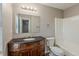 Bathroom features a vanity with granite countertops, a large mirror, and a tub/shower combo at 5786 Longbow Dr, Stone Mountain, GA 30087