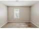 Bright bedroom with neutral walls, carpeted floors, and a window with blinds at 5786 Longbow Dr, Stone Mountain, GA 30087