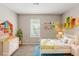 Cheerful bedroom with colorful decor, rug, and a window with horizontal blinds at 5786 Longbow Dr, Stone Mountain, GA 30087
