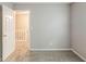 Empty bedroom with neutral walls, carpet, and an open door leading to the hallway at 5786 Longbow Dr, Stone Mountain, GA 30087