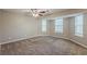 Bright bedroom featuring multiple windows, plush carpeting, and ample natural light at 5786 Longbow Dr, Stone Mountain, GA 30087