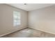 Bright bedroom with carpet, a window, and neutral wall paint at 5786 Longbow Dr, Stone Mountain, GA 30087