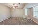 Well-lit bedroom features neutral walls, carpet, and multiple windows at 5786 Longbow Dr, Stone Mountain, GA 30087