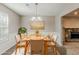 Bright dining room features a modern chandelier and table setting for elegant meals at 5786 Longbow Dr, Stone Mountain, GA 30087