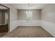 Neutral dining room features carpet and a modern light fixture for comfortable dining at 5786 Longbow Dr, Stone Mountain, GA 30087