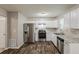 Modern kitchen with white cabinets and stainless steel appliances at 5786 Longbow Dr, Stone Mountain, GA 30087