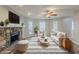 Staged living room features fireplace, plush seating, and a decorative rug at 5786 Longbow Dr, Stone Mountain, GA 30087