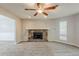 Living room featuring stone fireplace with mantel and ceiling fan at 5786 Longbow Dr, Stone Mountain, GA 30087