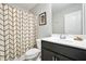Bathroom featuring dark wood cabinets and a decorative shower curtain at 5830 Keystone Pt, Lithonia, GA 30058