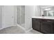 Bathroom featuring a glass enclosed shower and dark wood cabinets at 5830 Keystone Pt, Lithonia, GA 30058