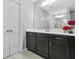 Bathroom featuring a large mirror over dark wood cabinets at 5830 Keystone Pt, Lithonia, GA 30058