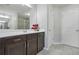 Bathroom featuring a large mirror over dark wood cabinets at 5830 Keystone Pt, Lithonia, GA 30058