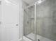 Bathroom featuring a glass enclosed shower and tiled walls at 5830 Keystone Pt, Lithonia, GA 30058