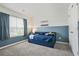 Cozy bedroom with blue accent wall and comfortable furnishings at 5830 Keystone Pt, Lithonia, GA 30058