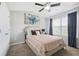 Cozy bedroom with ceiling fan, closet, and natural light from the window at 5830 Keystone Pt, Lithonia, GA 30058
