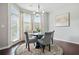 Bright dining area featuring a round table, chandelier, and a door leading to the outside at 5830 Keystone Pt, Lithonia, GA 30058