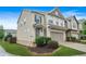 Side view of a beautiful two-story townhome with a two-car garage and well-maintained landscaping at 5830 Keystone Pt, Lithonia, GA 30058