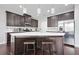 Modern kitchen features a large island with seating, stainless steel appliances, and stylish pendant lighting at 5830 Keystone Pt, Lithonia, GA 30058