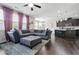 Spacious living room open to the kitchen with hardwood floors and large sectional sofa at 5830 Keystone Pt, Lithonia, GA 30058