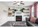 Comfortable living room with fireplace, built-in cabinets and floating shelves, and plush sofa seating at 5830 Keystone Pt, Lithonia, GA 30058