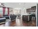 Open-concept living room and kitchen area with hardwood floors and modern stainless steel appliances at 5830 Keystone Pt, Lithonia, GA 30058