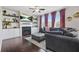 Comfortable living room with a fireplace, built-in shelves, hardwood floors, and a large sofa at 5830 Keystone Pt, Lithonia, GA 30058