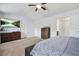 Comfortable carpeted main bedroom with dark wood furniture and a television at 5830 Keystone Pt, Lithonia, GA 30058