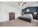 Main bedroom features a ceiling fan, ensuite bathroom and modern furnishings at 5830 Keystone Pt, Lithonia, GA 30058