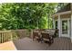Relax on this back deck featuring patio furniture and views of a private, wooded backyard at 963 Hawk Creek Trl, Lawrenceville, GA 30043