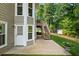 Backyard patio offers access to an upper deck and showcases the lawn with wooded backdrop at 963 Hawk Creek Trl, Lawrenceville, GA 30043