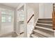 Carpeted basement stairs with a built-in bar leading to a spacious entertainment area at 963 Hawk Creek Trl, Lawrenceville, GA 30043