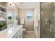 Bright bathroom featuring dual sinks, quartz counters, soft gray walls, and walk-in shower at 963 Hawk Creek Trl, Lawrenceville, GA 30043