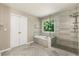 Bathroom with tiled floor, soaking tub, and glass shower enclosure at 963 Hawk Creek Trl, Lawrenceville, GA 30043