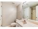 A bathroom with a tile floor, a single sink, a toilet, and a walk-in shower at 963 Hawk Creek Trl, Lawrenceville, GA 30043