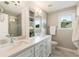 Bright bathroom featuring dual sinks, quartz counters, soft gray walls, and walk-in shower at 963 Hawk Creek Trl, Lawrenceville, GA 30043