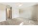 Neutral carpeted bedroom with ceiling fan and double door closet provides ample storage at 963 Hawk Creek Trl, Lawrenceville, GA 30043