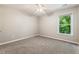 Bright, neutral bedroom with a double window and ceiling fan at 963 Hawk Creek Trl, Lawrenceville, GA 30043