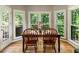 Sunlit dining area with views of the surrounding lush greenery, perfect for serene meals at 963 Hawk Creek Trl, Lawrenceville, GA 30043