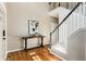 Elegant foyer with hardwood floors, staircase, and stylish console table, creating a welcoming entrance at 963 Hawk Creek Trl, Lawrenceville, GA 30043