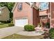 Well-kept red brick home with a two-car garage, landscaped front yard, and a traditional architectural style at 963 Hawk Creek Trl, Lawrenceville, GA 30043