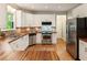 Contemporary kitchen with stainless steel appliances, wood counters, and custom cabinets for storage at 963 Hawk Creek Trl, Lawrenceville, GA 30043