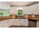 Bright open kitchen with white cabinets, butcher block counters and stainless steel appliances at 963 Hawk Creek Trl, Lawrenceville, GA 30043